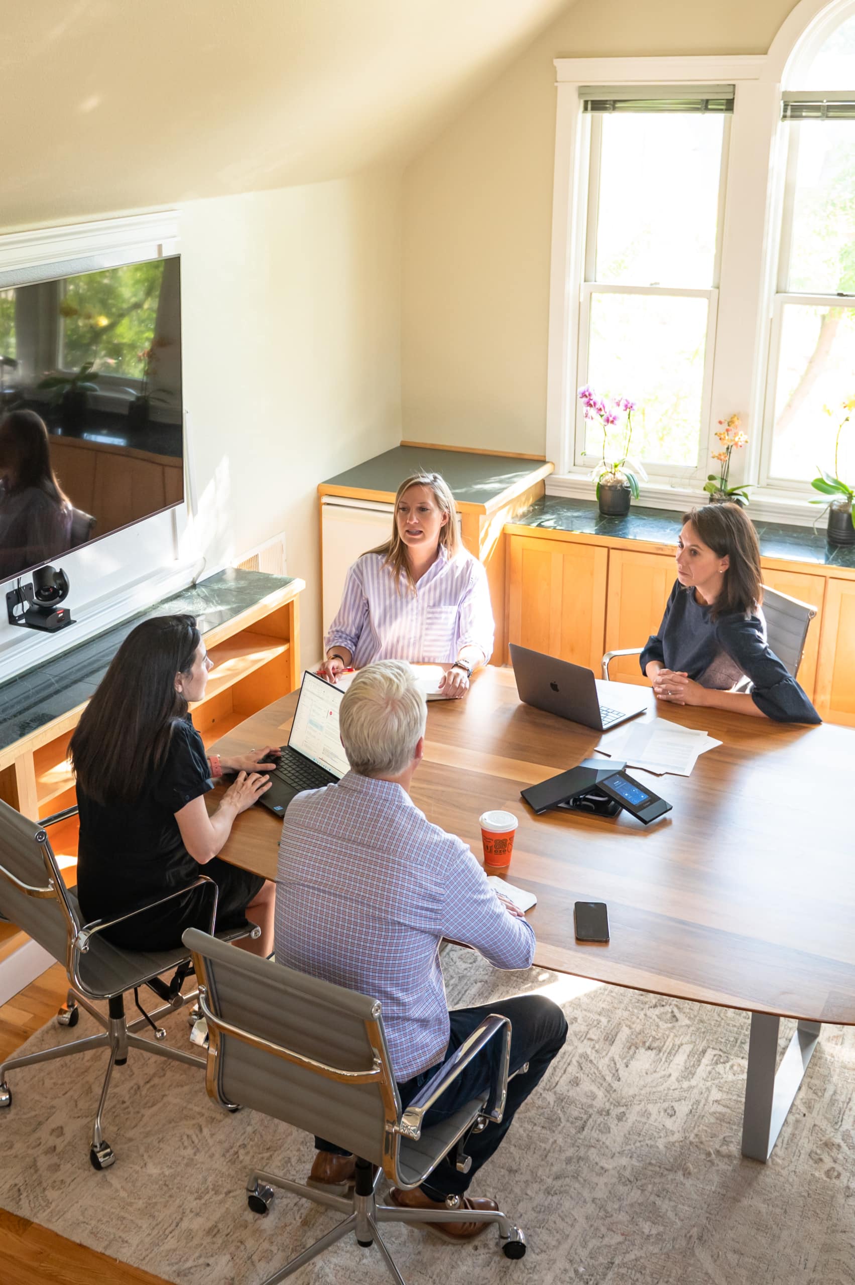 Four people talking at a conference table