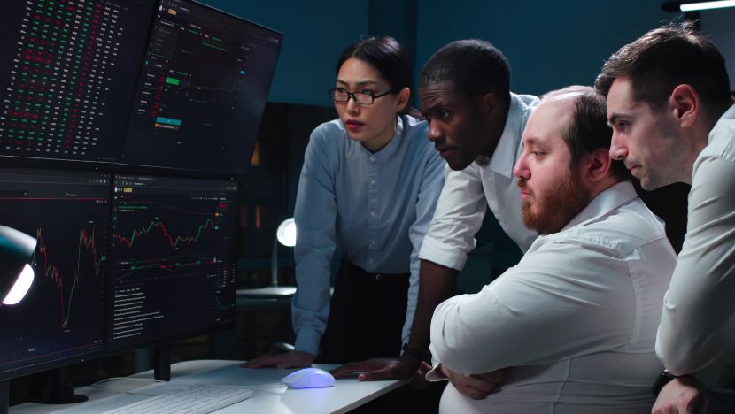 Team looking at data on computer screens