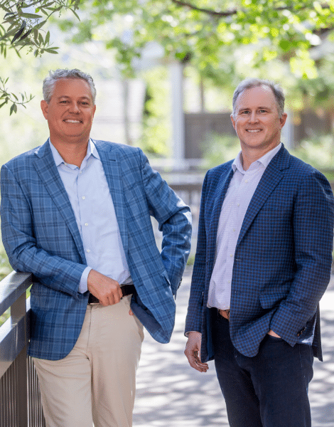 Two businessmen smiling